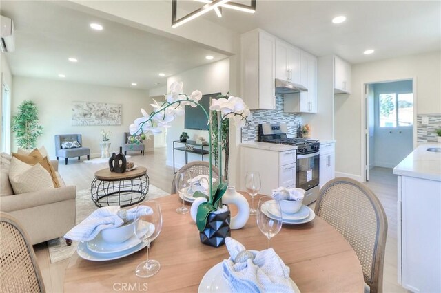 16928 Pocono St, La Puente, CA 91744 - dining room featuring light wood-type flooring, recessed lighting, baseboards, and a wall unit AC