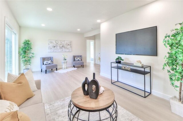 16928 Pocono St, La Puente, CA 91744 - living room featuring wood finished floors, healthy amount of natural light, recessed lighting, and baseboards