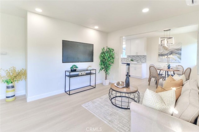 16928 Pocono St, La Puente, CA 91744 - living area featuring light wood finished floors, recessed lighting, and baseboards