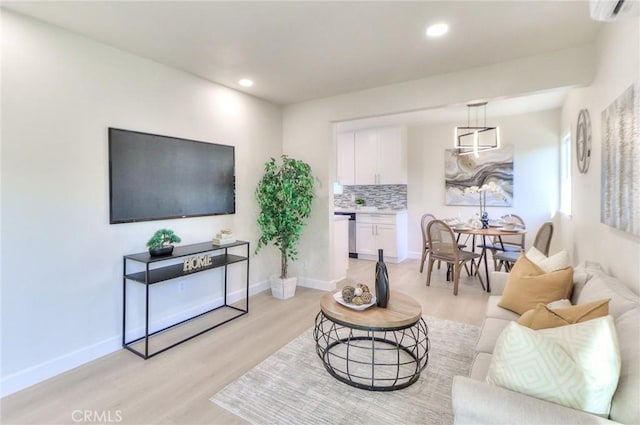 16928 Pocono St, La Puente, CA 91744 - living area featuring light wood-style floors, recessed lighting, baseboards, and a wall unit AC