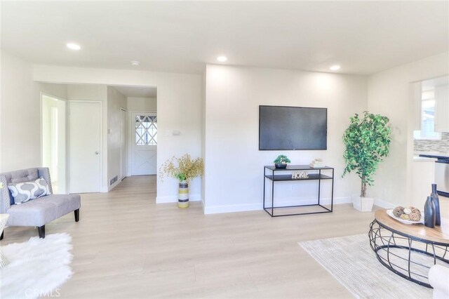 16928 Pocono St, La Puente, CA 91744 - living room featuring recessed lighting, light wood-style flooring, and baseboards