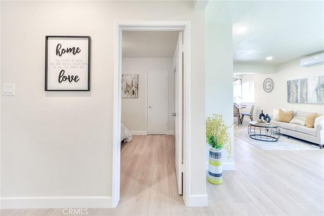 16928 Pocono St, La Puente, CA 91744 - corridor with a wall unit AC, baseboards, wood finished floors, and recessed lighting