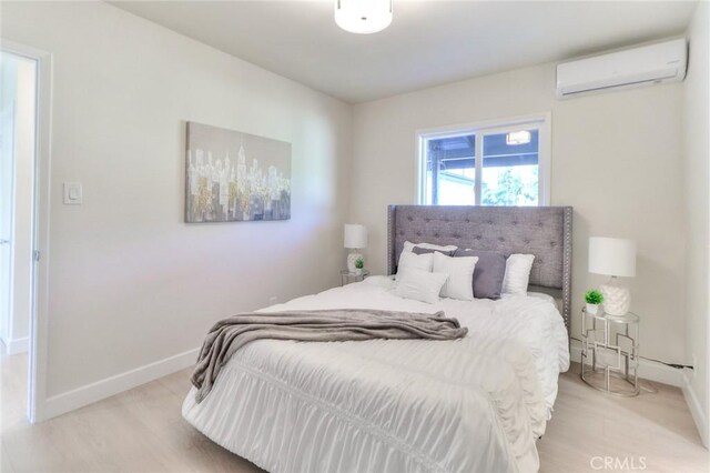16928 Pocono St, La Puente, CA 91744 - bedroom with a wall mounted air conditioner, baseboards, and wood finished floors