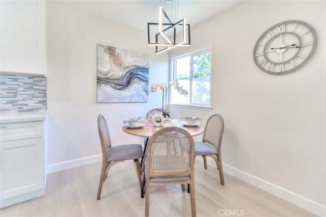 16928 Pocono St, La Puente, CA 91744 - dining space with light wood-type flooring, baseboards, and a chandelier