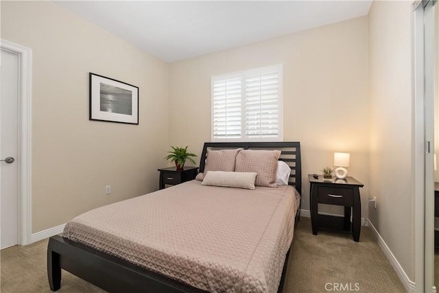 carpeted bedroom featuring baseboards