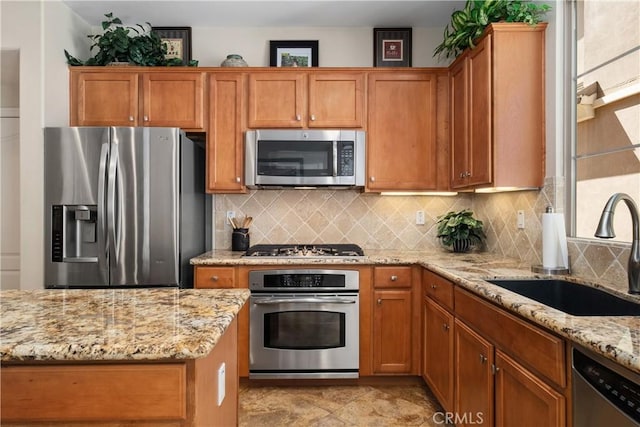 182 Rhapsody, Irvine, CA 92620 - kitchen with appliances with stainless steel finishes, backsplash, light stone countertops, and brown cabinetry
