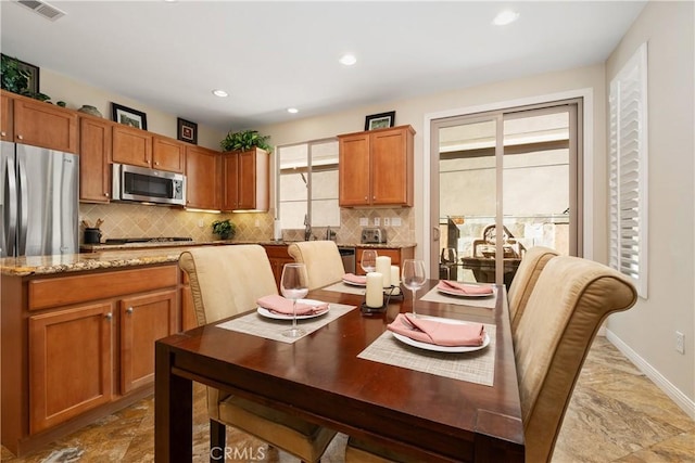 dining area with recessed lighting and baseboards