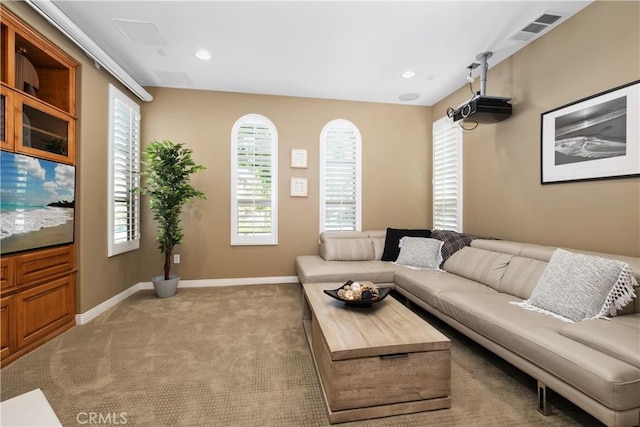 carpeted living area featuring baseboards and recessed lighting