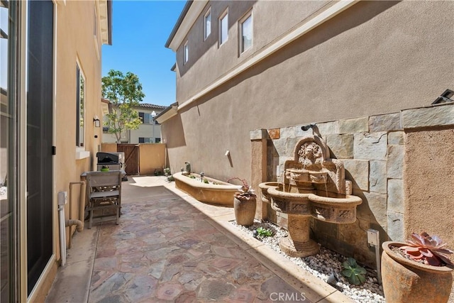 view of patio / terrace featuring fence