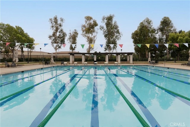 community pool with a pergola