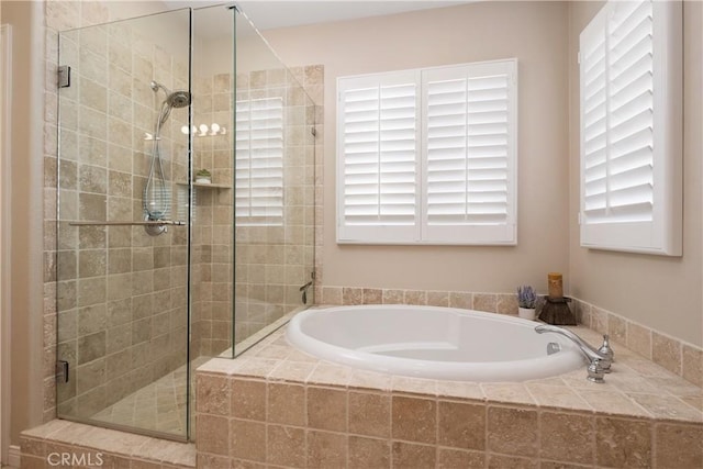 full bath featuring a shower stall and a bath