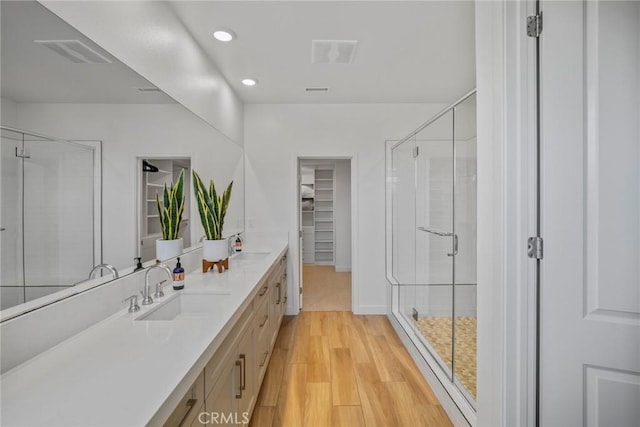 2047 Doheny Way, Dana Point, CA 92629 - full bath featuring a shower stall, a walk in closet, vanity, recessed lighting, and wood finished floors