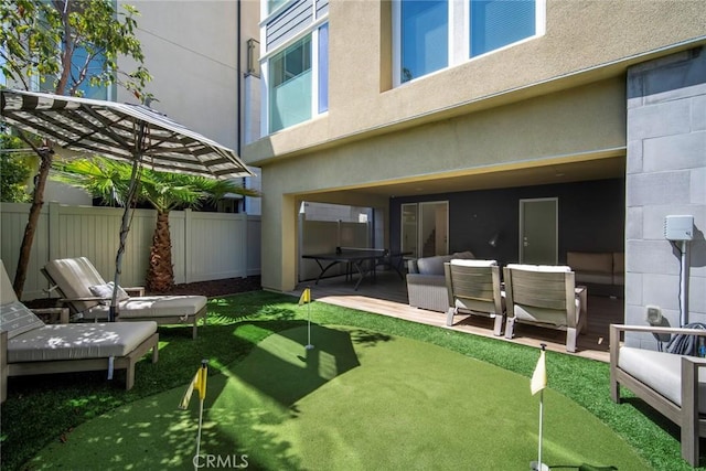 2047 Doheny Way, Dana Point, CA 92629 - back of property with an area to practice putting, fence, stucco siding, and a patio