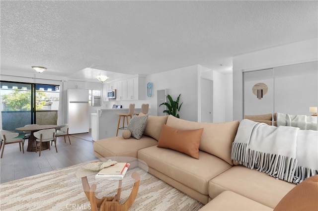 18530 Hatteras St Unit 209, Tarzana, CA 91356 - living area with a textured ceiling and light wood-type flooring