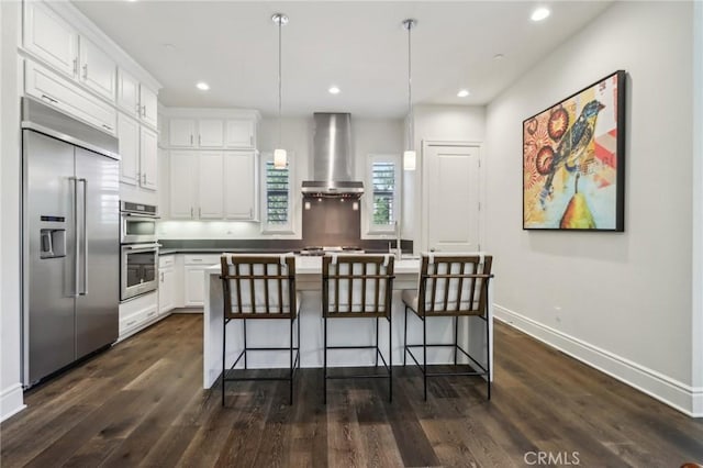 132 Interval, Irvine, CA 92618 - kitchen with appliances with stainless steel finishes, wall chimney range hood, white cabinets, dark wood-type flooring, and recessed lighting