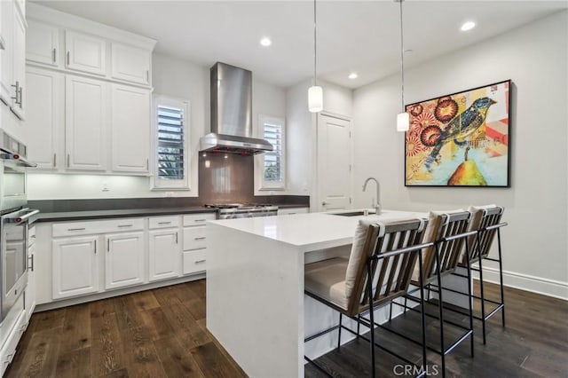 132 Interval, Irvine, CA 92618 - kitchen with extractor fan, a sink, dark wood-style floors, recessed lighting, and a center island with sink