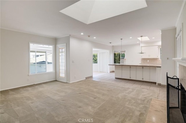 unfurnished living room featuring light colored carpet, recessed lighting, crown molding, baseboards, and light tile patterned flooring