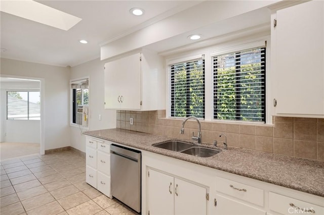 kitchen featuring stainless steel dishwasher, a sink, light tile patterned floors, tasteful backsplash, and recessed lighting