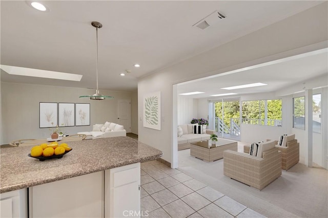 living room featuring healthy amount of natural light, recessed lighting, light tile patterned floors, and baseboards