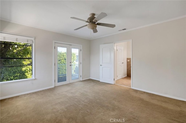 spare room with carpet, french doors, baseboards, and crown molding