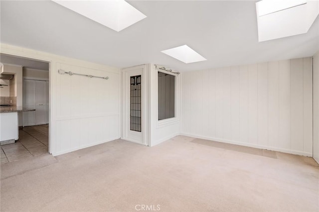 carpeted spare room with a skylight