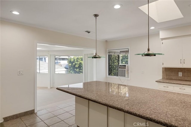 kitchen featuring white cabinets, decorative light fixtures, recessed lighting, light tile patterned floors, and tasteful backsplash