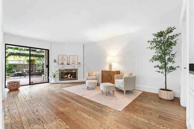 15 Firestone Unit 4, Irvine, CA 92614 - sitting room featuring hardwood / wood-style floors, a fireplace, and baseboards