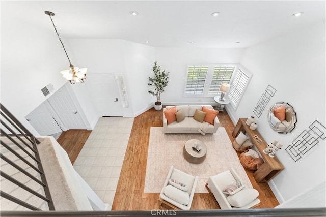 15 Firestone Unit 4, Irvine, CA 92614 - living area with a chandelier, wood finished floors, recessed lighting, stairway, and baseboards