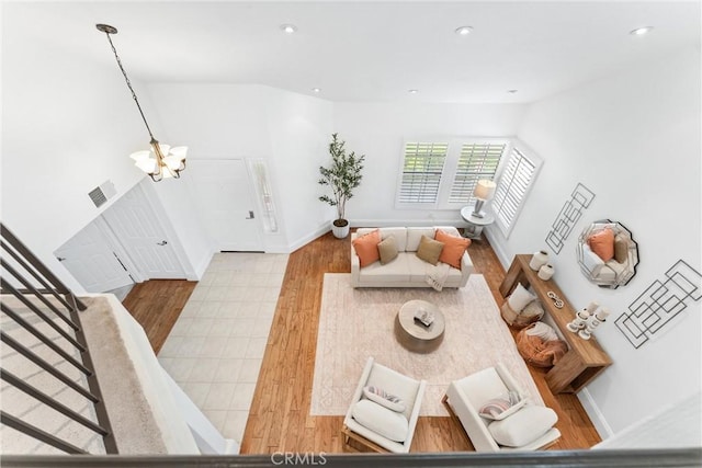15 Firestone Unit 4, Irvine, CA 92614 - living room with a chandelier, wood finished floors, recessed lighting, stairway, and baseboards