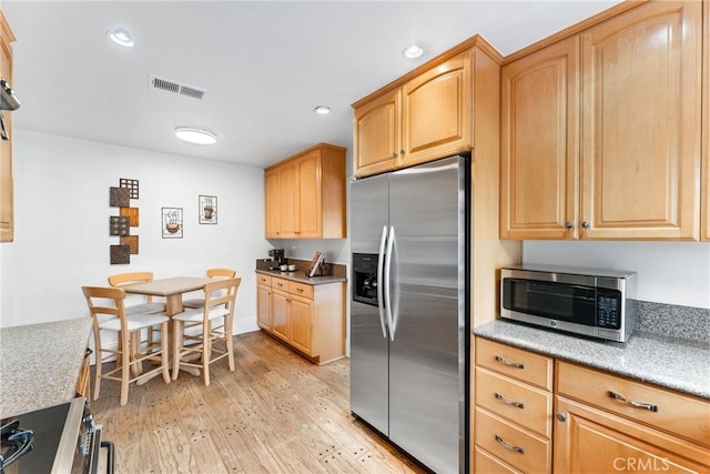 15 Firestone Unit 4, Irvine, CA 92614 - kitchen featuring stainless steel appliances, light wood-style floors, recessed lighting, light brown cabinets, and baseboards