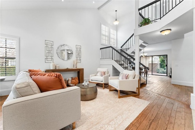 15 Firestone Unit 4, Irvine, CA 92614 - living area featuring high vaulted ceiling, stairs, wood-type flooring, and baseboards