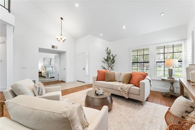15 Firestone Unit 4, Irvine, CA 92614 - living area featuring wood-type flooring, a chandelier, recessed lighting, baseboards, and high vaulted ceiling