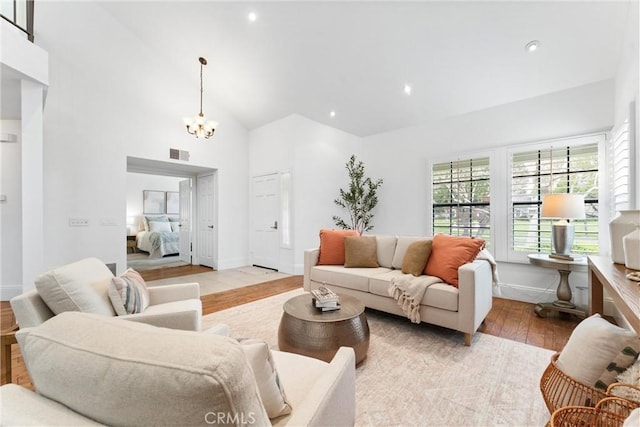15 Firestone Unit 4, Irvine, CA 92614 - living room featuring wood finished floors, a chandelier, recessed lighting, baseboards, and high vaulted ceiling