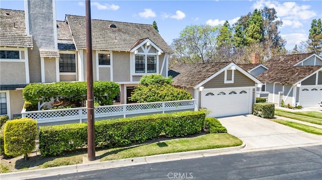 15 Firestone Unit 4, Irvine, CA 92614 - view of front of property with stucco siding, a chimney, and driveway