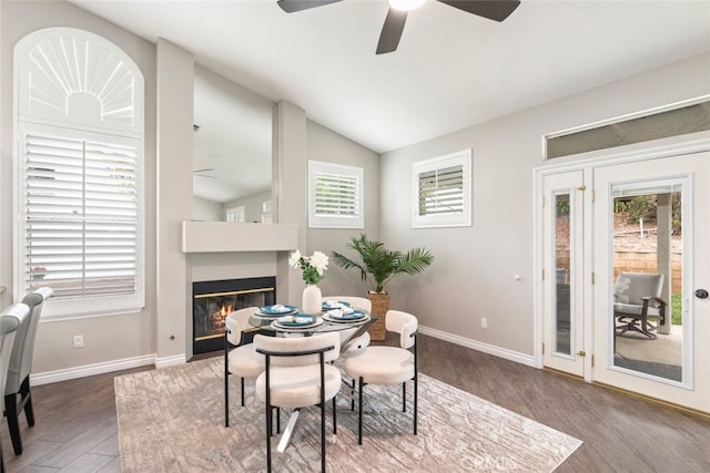 1044 Shadow Crest Cir, Corona, CA 92881 - dining space with ceiling fan, a glass covered fireplace, wood finished floors, lofted ceiling, and baseboards
