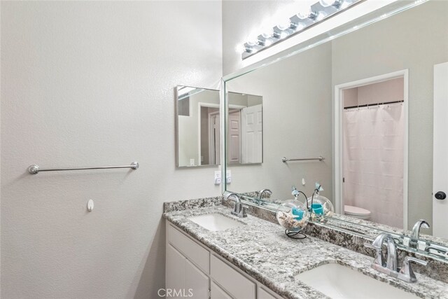 1044 Shadow Crest Cir, Corona, CA 92881 - full bathroom featuring double vanity, toilet, and a shower with shower curtain