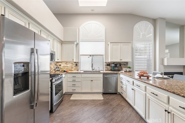 1044 Shadow Crest Cir, Corona, CA 92881 - kitchen with appliances with stainless steel finishes, a sink, tasteful backsplash, wood finished floors, and light stone countertops