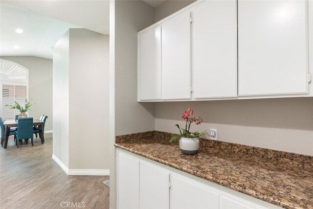 1044 Shadow Crest Cir, Corona, CA 92881 - kitchen featuring baseboards, light wood finished floors, white cabinets, dark stone countertops, and recessed lighting