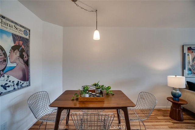 dining area with wood finished floors and baseboards