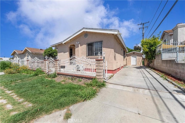 view of front of property with concrete driveway, fence, stucco siding, and a garage