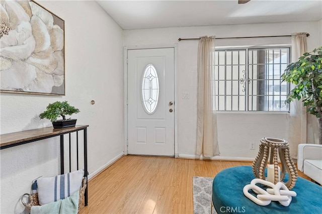 entryway with wood finished floors and baseboards