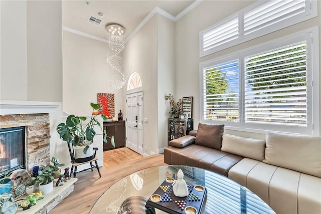 166 Alta St Unit B, Arcadia, CA 91006 - living area featuring crown molding, light wood finished floors, a fireplace, a high ceiling, and baseboards