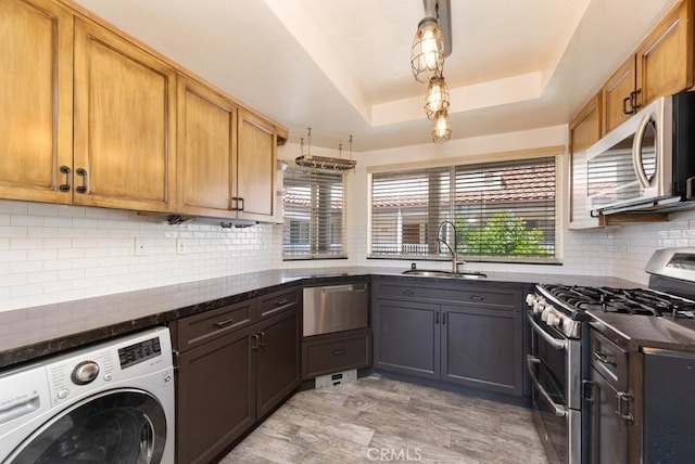 3306 Darby St Unit 402, Simi Valley, CA 93063 - kitchen featuring washer / clothes dryer, stainless steel appliances, a sink, a raised ceiling, and tasteful backsplash