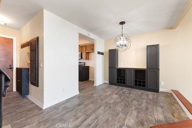 3306 Darby St Unit 402, Simi Valley, CA 93063 - unfurnished living room with wood finished floors, a chandelier, and baseboards