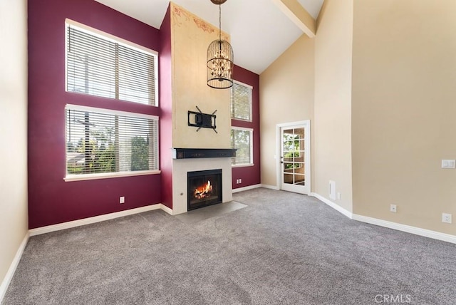3306 Darby St Unit 402, Simi Valley, CA 93063 - unfurnished living room with high vaulted ceiling, carpet, a chandelier, baseboards, and a fireplace with flush hearth