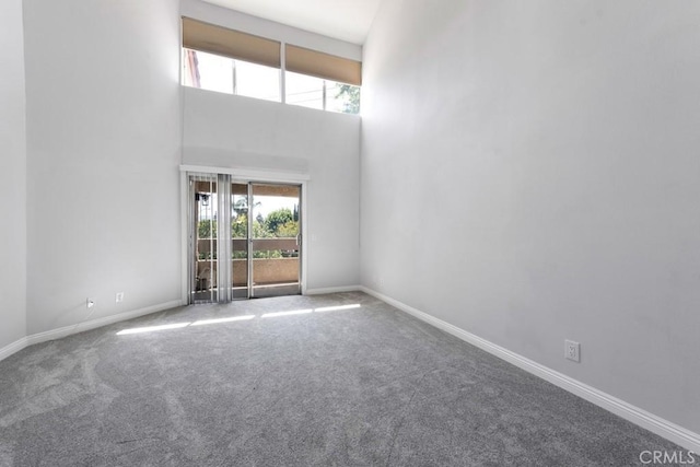 3306 Darby St Unit 402, Simi Valley, CA 93063 - spare room featuring carpet floors, baseboards, and a high ceiling