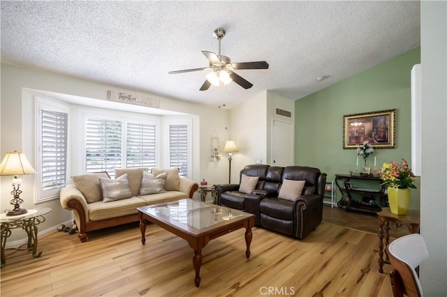 18993 Janisse Ln, Lake Elsinore, CA 92530 - living area with a textured ceiling, a ceiling fan, light wood-style floors, and vaulted ceiling