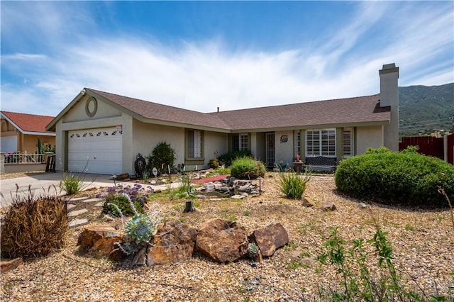 18993 Janisse Ln, Lake Elsinore, CA 92530 - ranch-style house with stucco siding, a garage, concrete driveway, and a chimney