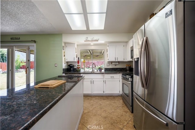 18993 Janisse Ln, Lake Elsinore, CA 92530 - kitchen featuring appliances with stainless steel finishes, a sink, white cabinets, and light tile patterned floors