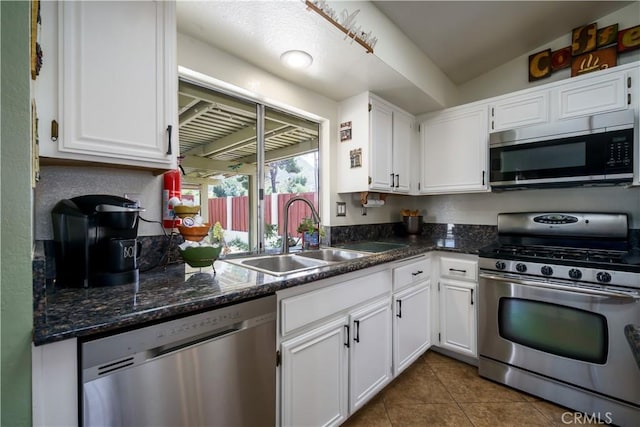 18993 Janisse Ln, Lake Elsinore, CA 92530 - kitchen featuring appliances with stainless steel finishes, a sink, white cabinets, and dark tile patterned flooring
